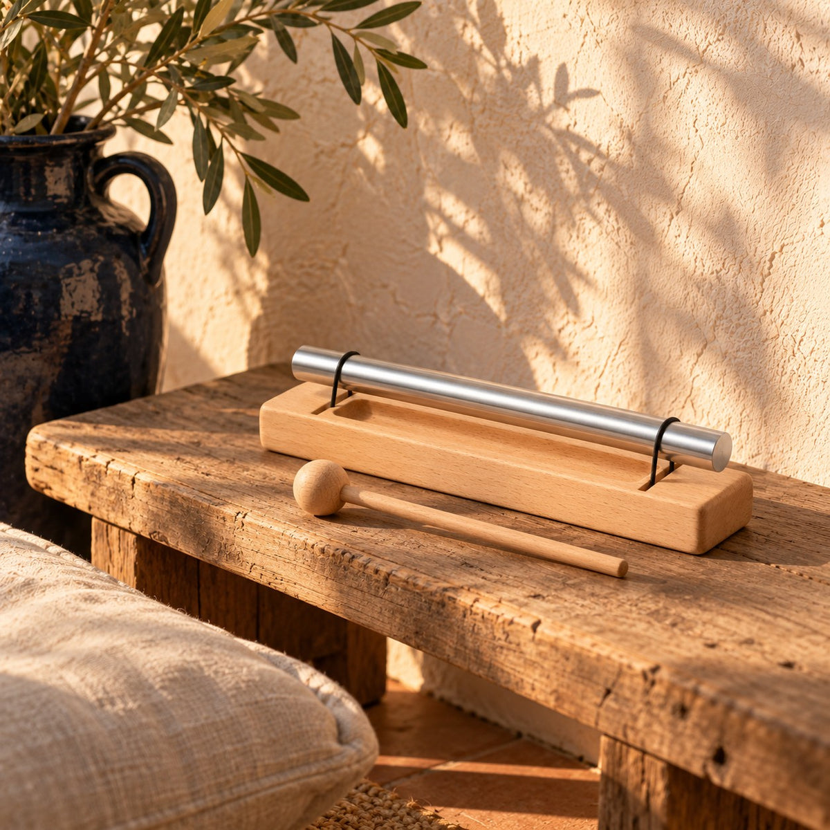 Single-tone chime on a wooden bench in warm afternoon light