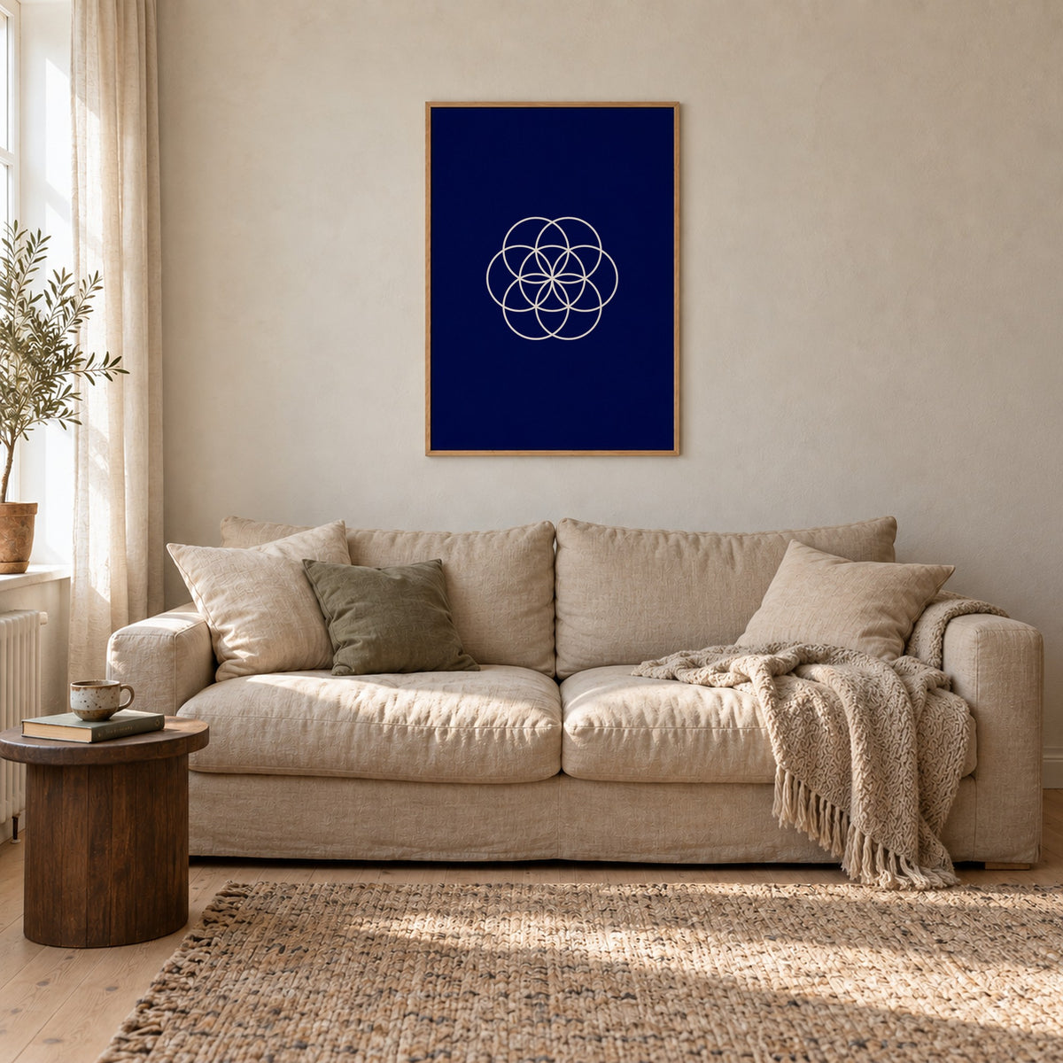Poster Bloom, navy, in an oak frame above a linen sofa