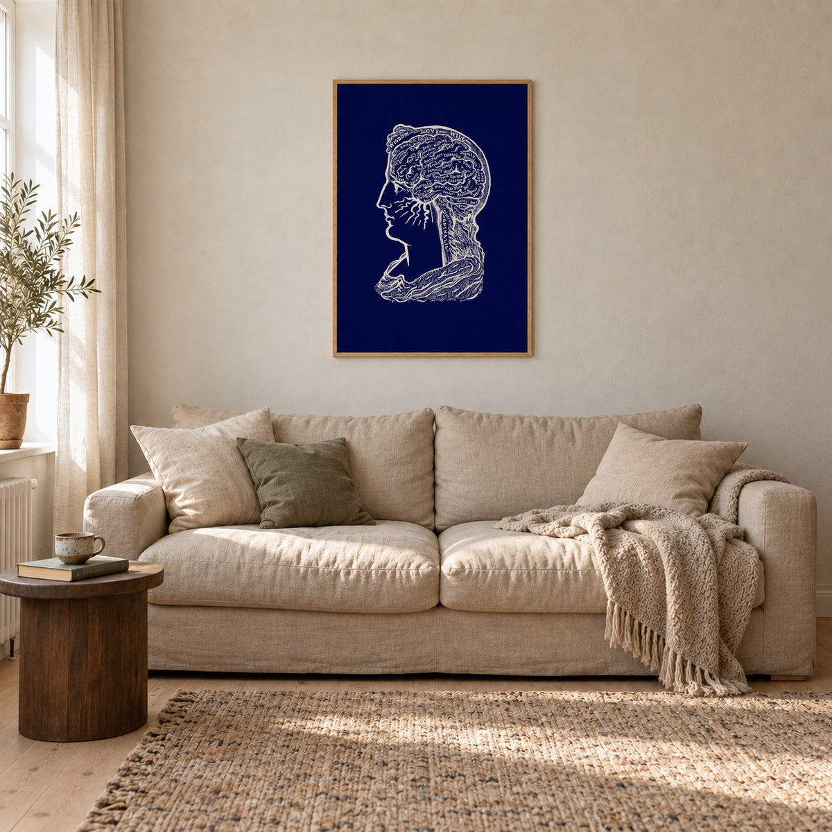 Poster Sereena, navy, in an oak frame above a linen sofa